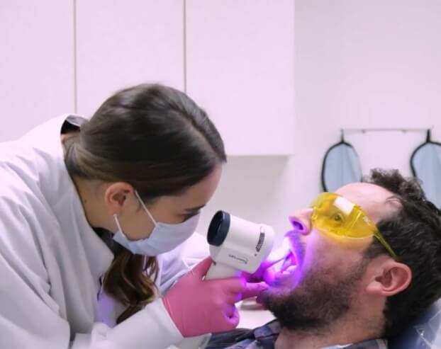 Dentist examining patient's smile