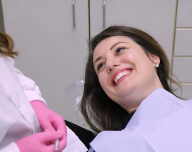 Woman smiling at dentist during dental visit