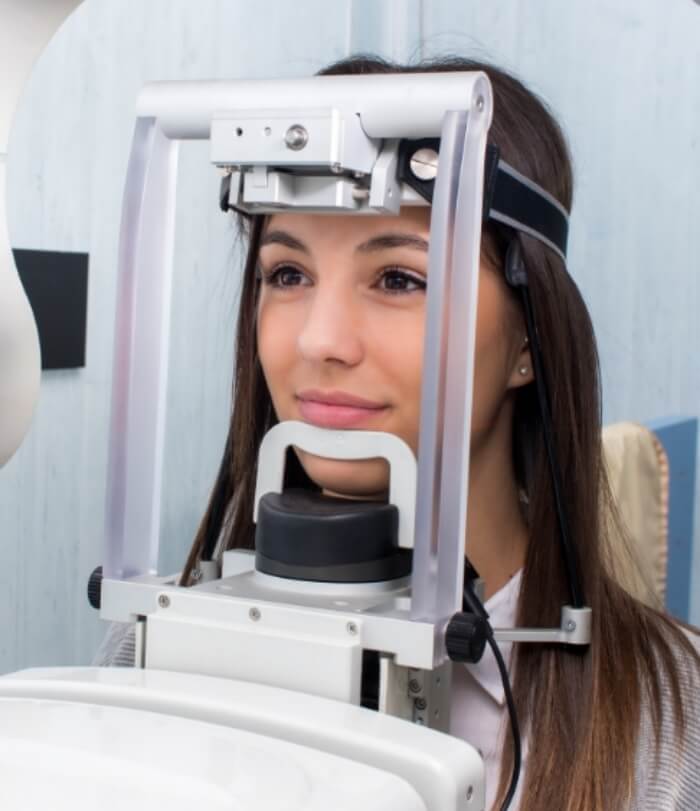 Woman receiving 3 D C T cone beam x-ray scans