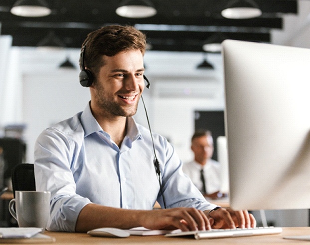 Office employee with great smile talking on phone