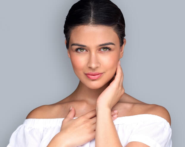 Woman smiling confidently after Botox and dermal filler treatment