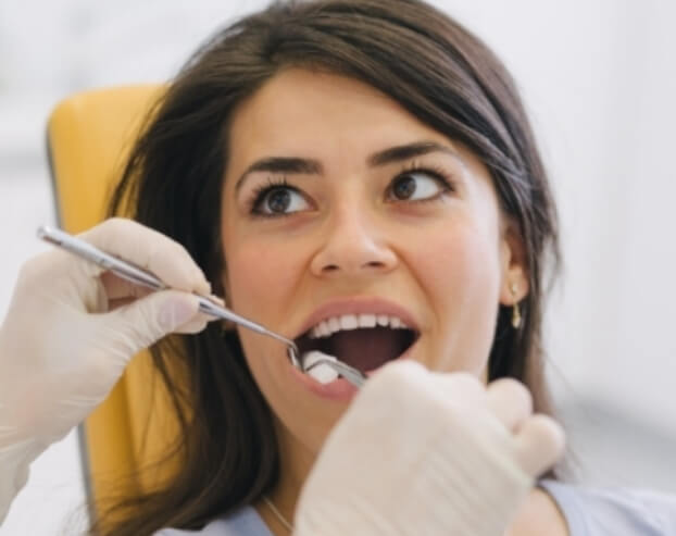 Patient receiving an oral cancer screening