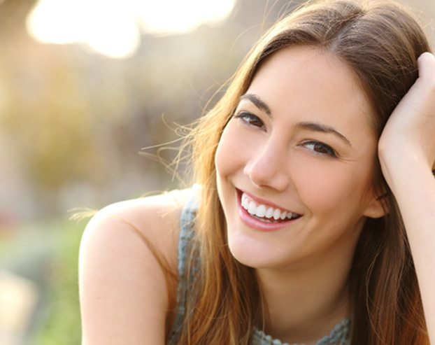woman smiling after getting dental crown in Boston