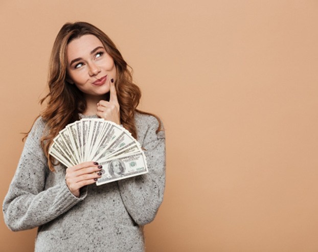 woman thinking about the cost of emergency dentistry in Boston