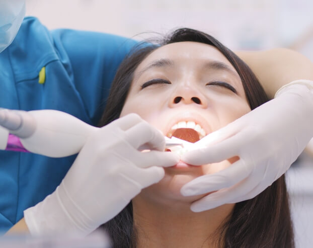 Dental patient receiving scaling and root planing treatment