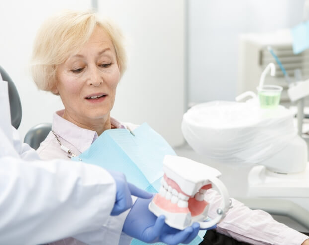 Dentist and patient discussing the benefits of dental implant supported dentures