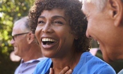 Smiling woman enjoying the benefits of dental implants