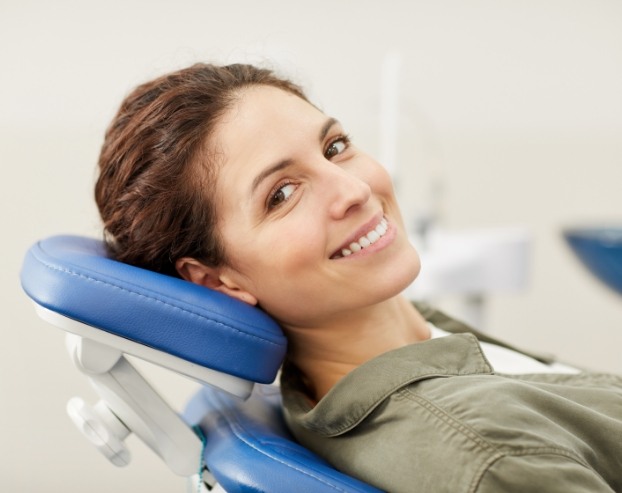Woman smiling while visiting the dentist