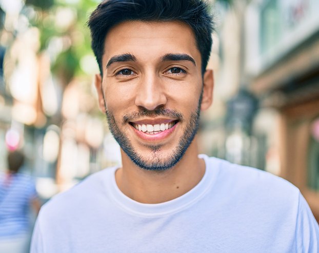 man smiling after wearing Invisalign in Boston