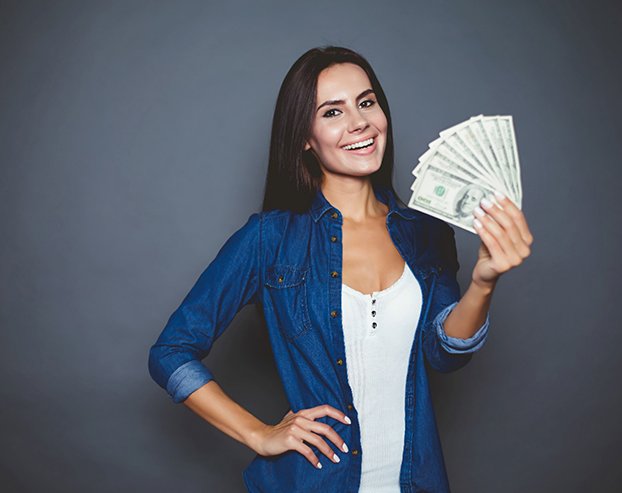 a woman holding money to pay for Invisalign in Boston