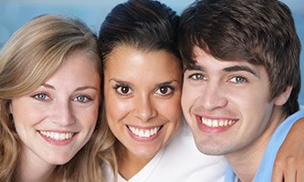 Three young people with flawless smiles