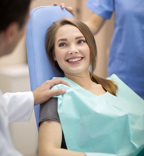 Relaxed young woman smiling in dental chair