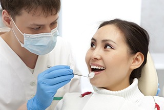Woman smiling at her Boston dentist during a checkup