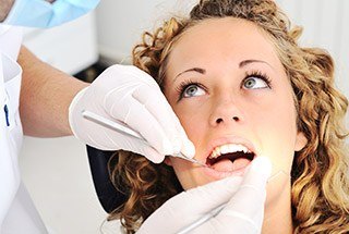 Woman receiving oral cancer screening