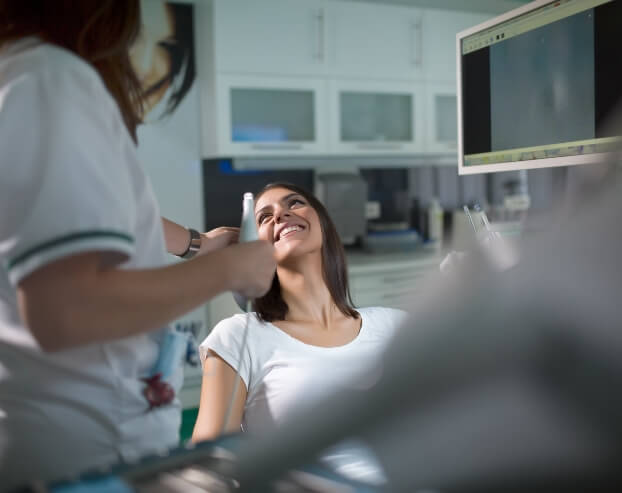 Woman smiling during root canal therapy visit