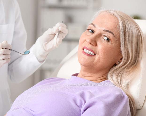 a woman smiling after receiving veneers in Boston