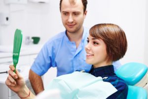 woman looking in dental mirror