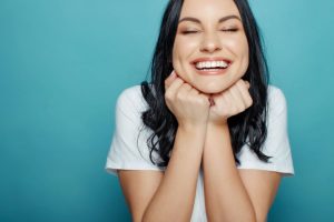 Smiling woman who just visited her cosmetic dentist in the Financial District