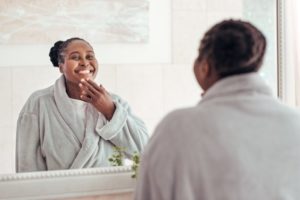 person looking in their bathroom mirror and wondering whether to get BOTOX in Downtown Boston