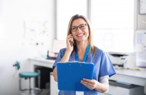 dentist in downtown Boston talking on phone and holding clipboard 