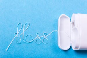 Floss spelling "floss" on blue background