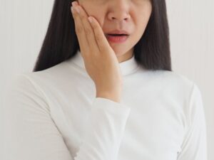 a woman holding her mouth after getting a BOTOX injection