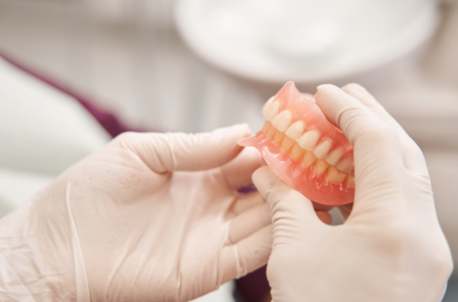 Dentist holding dentures